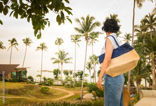 Female tourists look at the sea with relaxation at the seaside attractions.