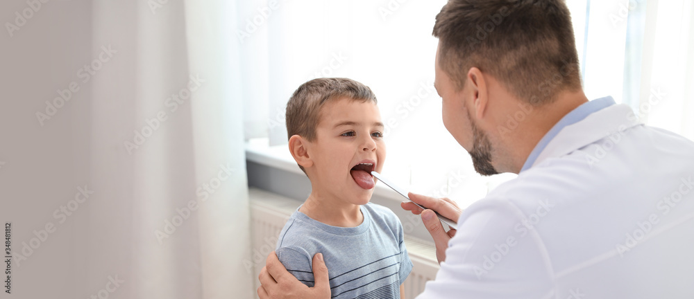Doctor examining little patient in clinic, space for text. Banner design