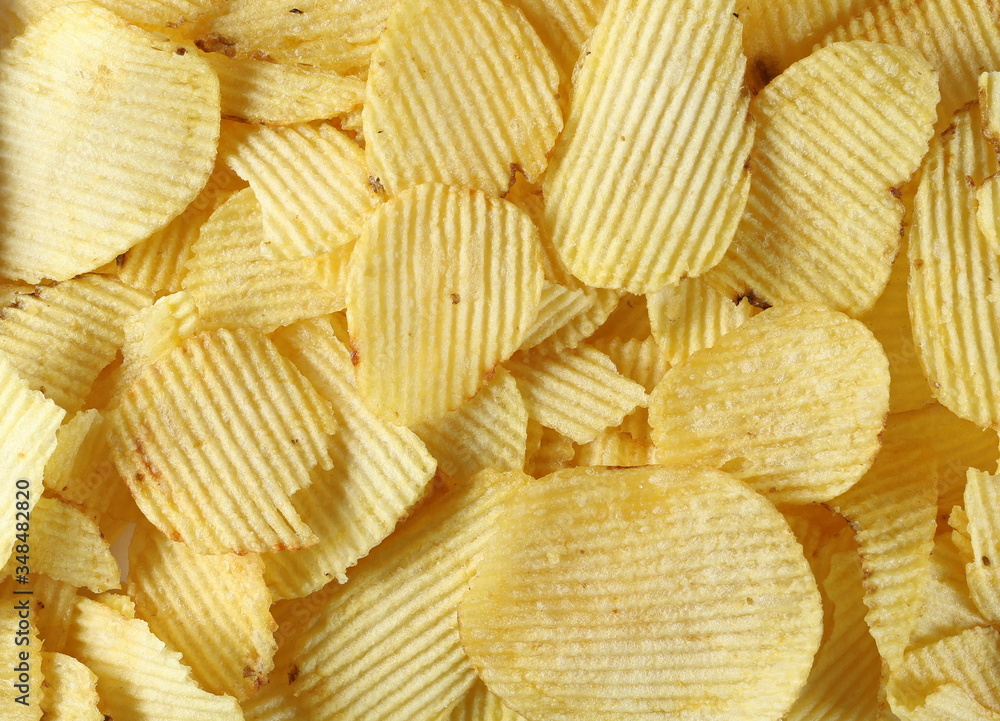 Potato chips, crisps, party snacks texture and background Potato chips, crisps, party snacks texture and background