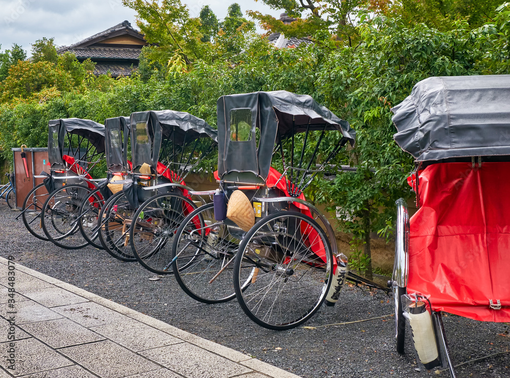 A pulled rickshaw carts (or ricksha) on the street of old Kyoto. Kyoto. Japan A pulled rickshaw carts (or ricksha) on the street of old Kyoto. Kyoto. Japan