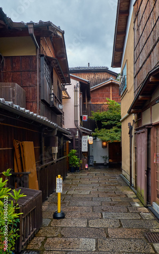 Small narrow street surrounded by the typical Kyoto machiya buildings. Higashiyama. Kyoto. Japan