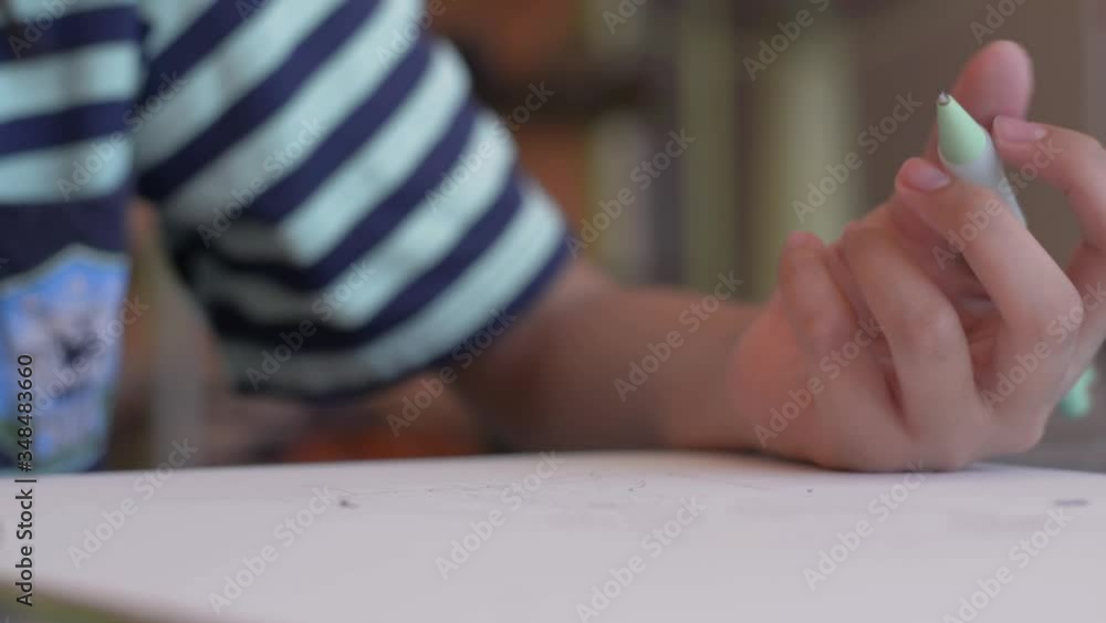 Schoolgirl drawing on a paper with pencil at home. Creative young children is creating works on art paper with his own imagination. Schoolgirl drawing on a paper with pencil at home. Creative young children is creating works on art paper with his own imagination.