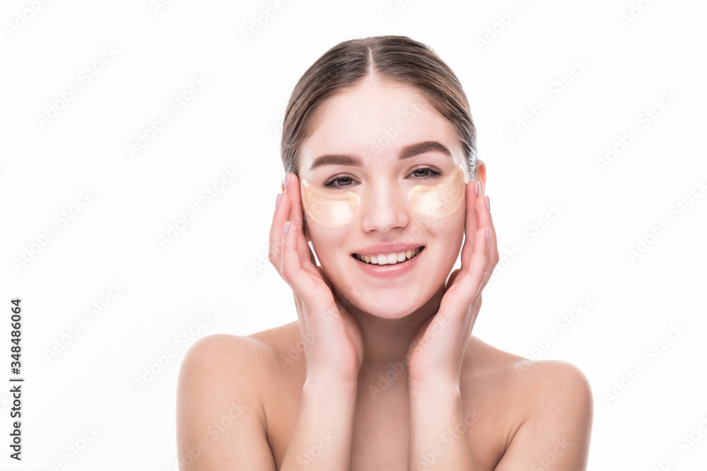 Close-up of a young woman with patches under eyes from wrinkles and dark circles isolated on white background Close-up of a young woman with patches under eyes from wrinkles and dark circles isolated on white background