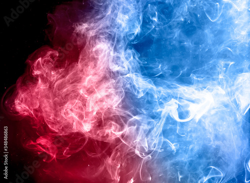 red and blue colorful smoke on dark background.
