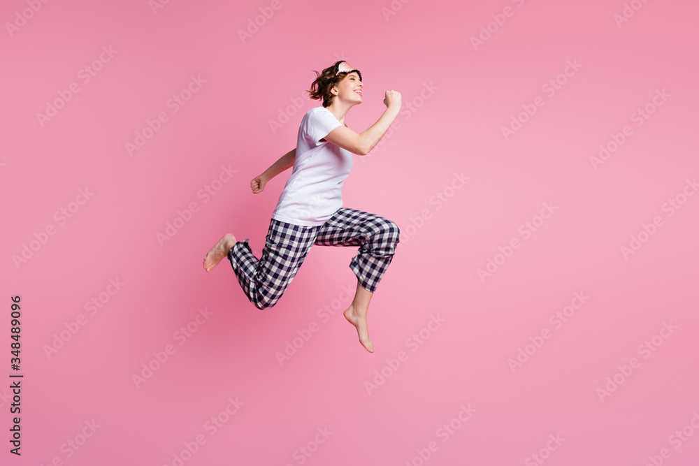 Full size profile photo of funny lady jump high up rush sales shopping didn't change sleep clothes wear sleep mask white t-shirt plaid pajama pants barefoot isolated pink color background Full size profile photo of funny lady jump high up rush sales shopping didn't change sleep clothes wear sleep mask white t-shirt plaid pajama pants barefoot isolated pink color background