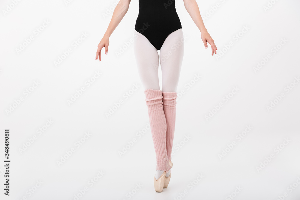 Cropped image of caucasian young woman ballerina dancing gracefully