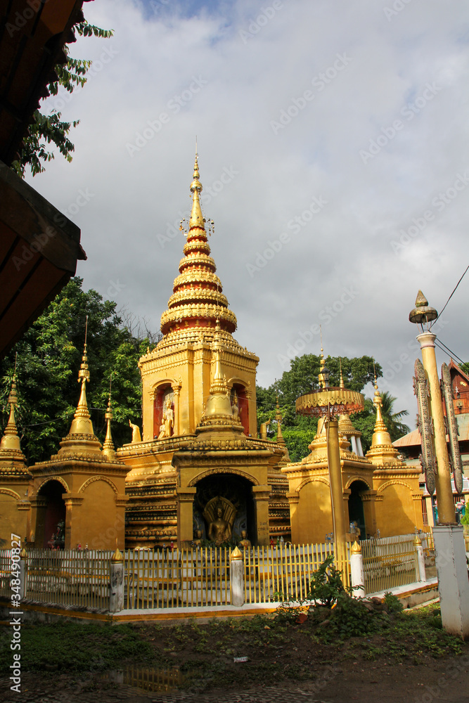 Fototapeta premium Golden temple with cloudy sky in Pai, Thailand
