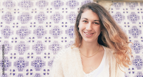 Young pretty woman student in Portugal. A wall of blue azulejo - traditional Portuguese tiles