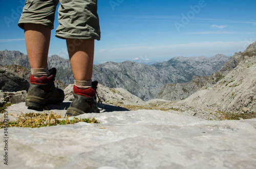 hiker feet high up in the picos de europa mountains in summer with blue sky