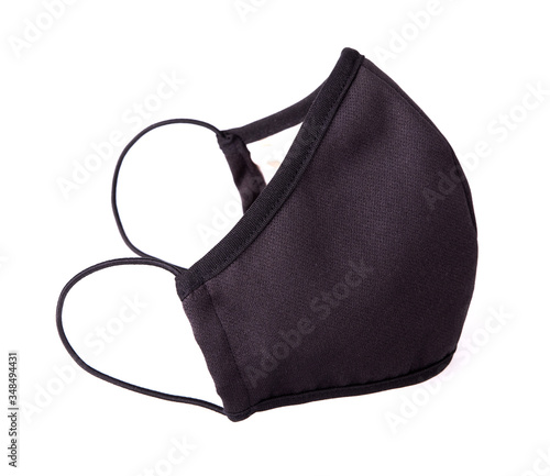 Black fabric facial mask for health protection isolated on white background. Ear-loop mask to cover the mouth and nose. Trendy clothing product for self protection from diseases, corona virus covid19