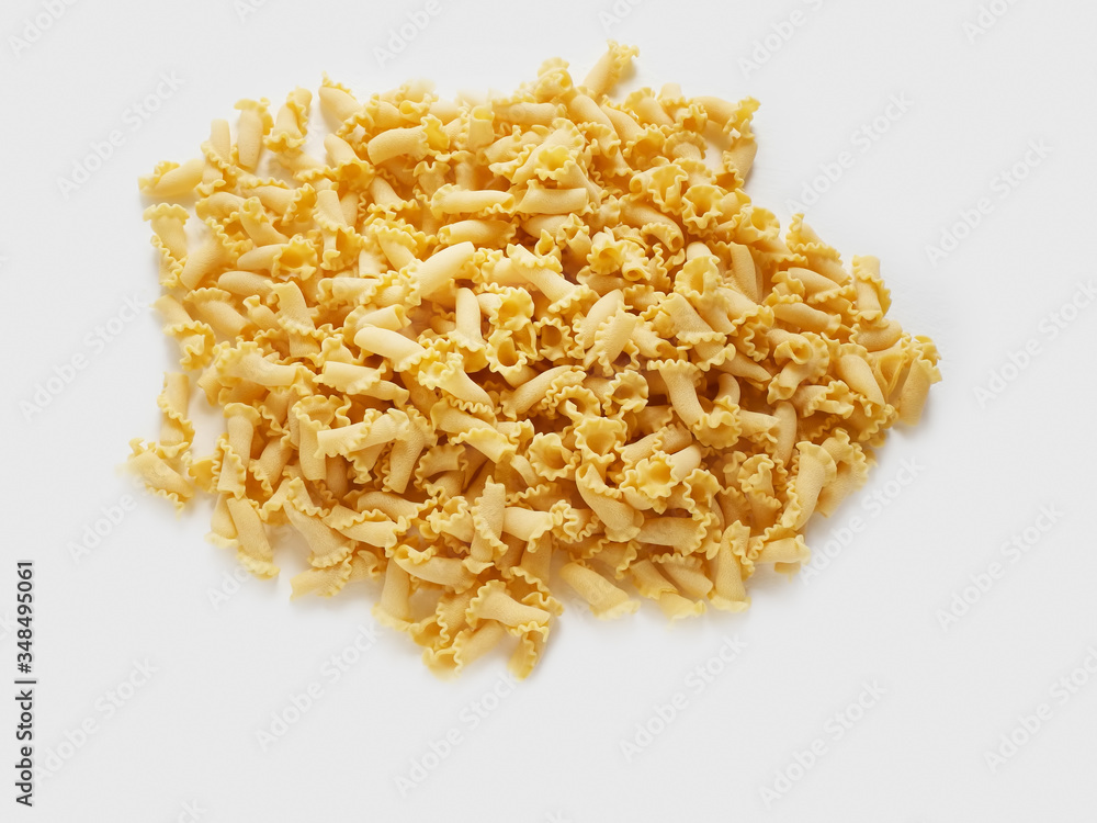 uncooked pasta campanelle on white background uncooked pasta campanelle on white background