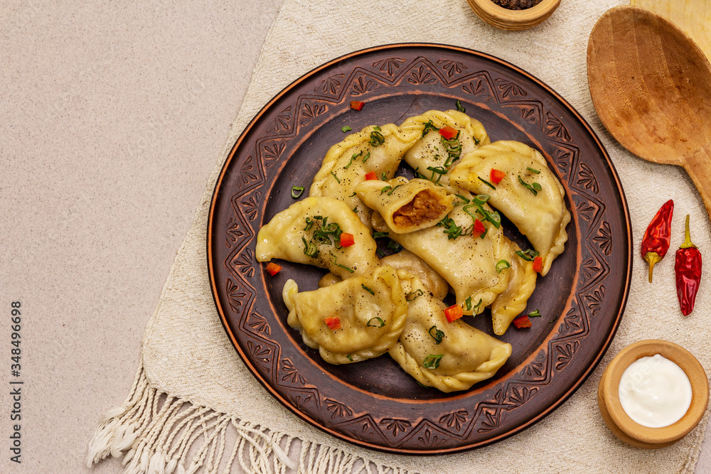Dumplings stuffed stewed cabbage and sour cream. Traditional Ukrainian dish varenyky Dumplings stuffed stewed cabbage and sour cream. Traditional Ukrainian dish varenyky