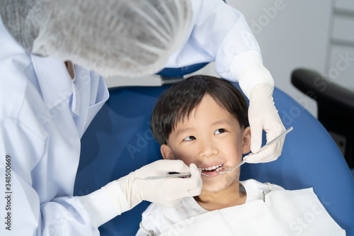 A boy having teeth examined at dentists  Healthy lifestyle  healthcare  and medicine concept.