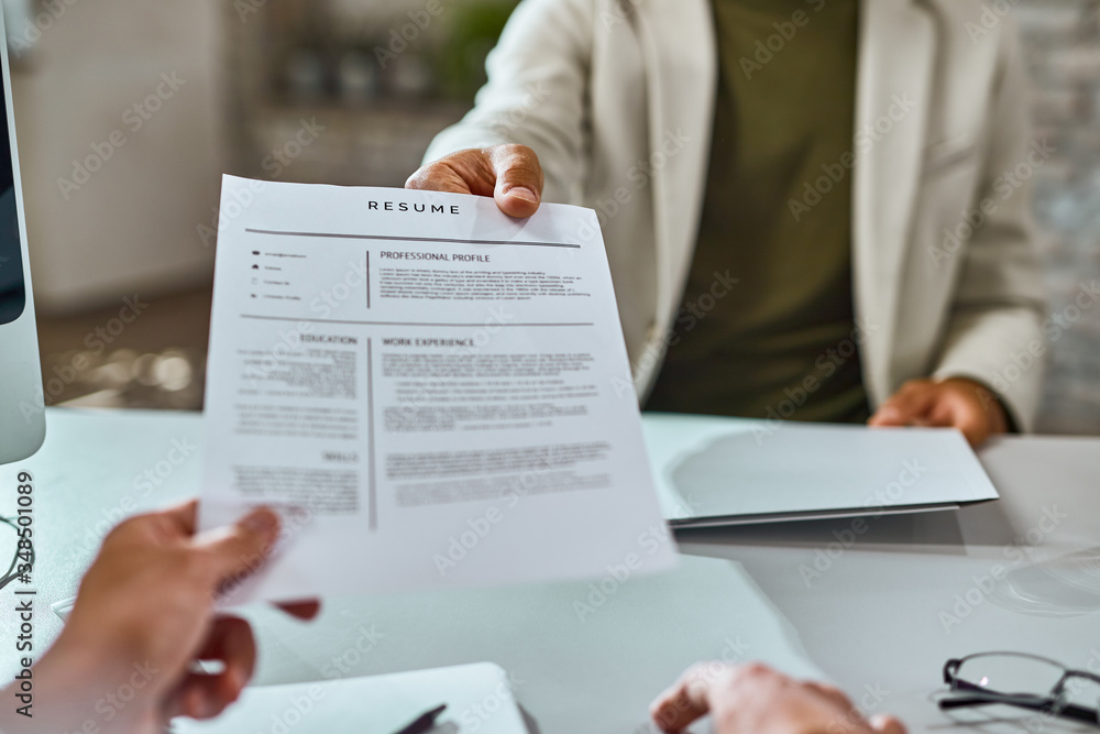 Close-up of candidate giving his CV on a job interview. Close-up of candidate giving his CV on a job interview.