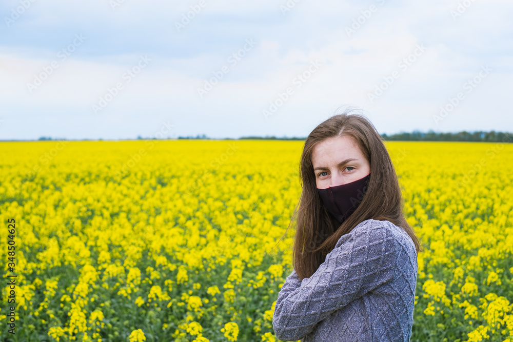 portrait of a girl in a black mask on a background of yellow flowers.outdoors
portrait of a girl in a black mask on a background of yellow flowers.outdoors