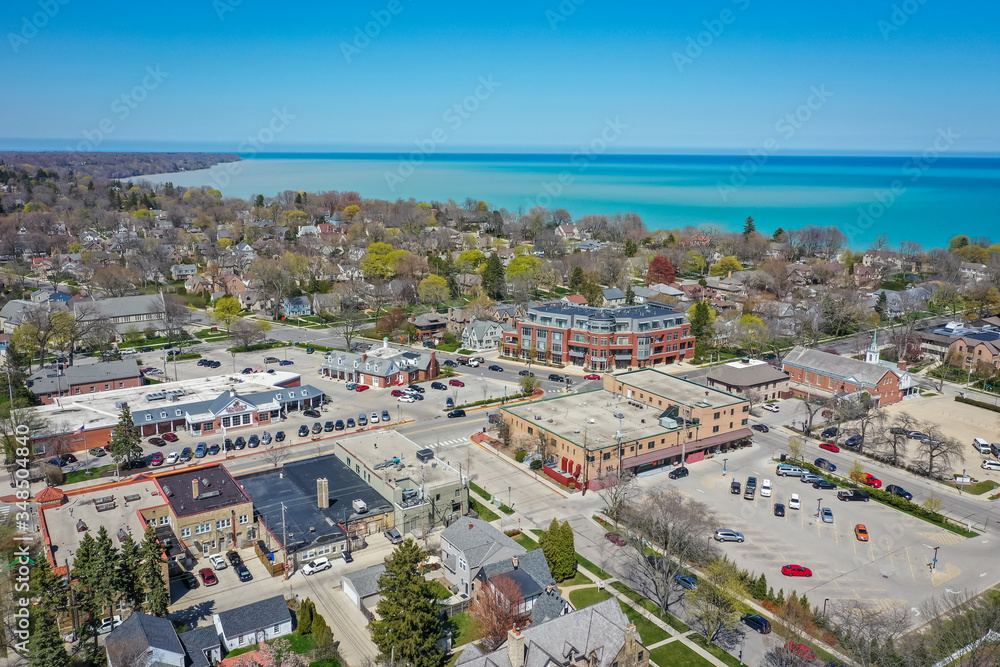 Milwaukee, WI / USA - May 12, 2020:  Aerial view of shopping district of suburban Whitefish Bay Wisconsin. Scene looks north east towards Lake Michigan