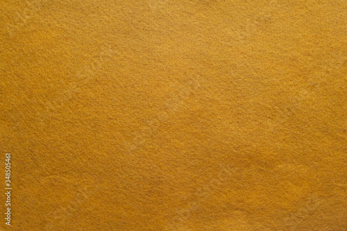 mustard felt material. horizontal fabric background: close-up yellow felt 