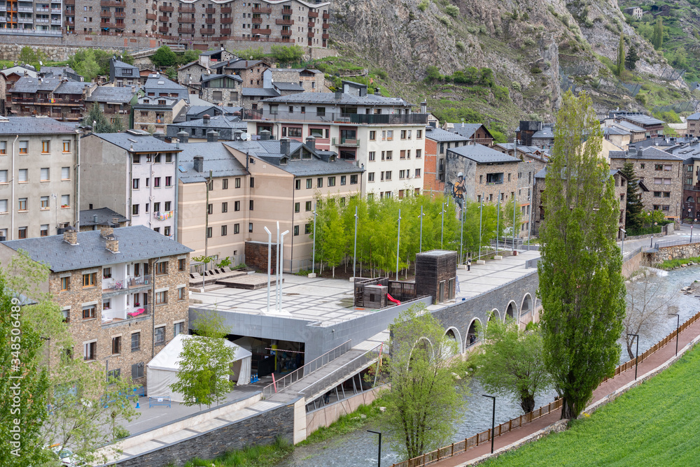 Fototapeta premium Cityscape of Canillo, Andorra in spring with the church in the background and the Palau del Gel on a sunny day.
