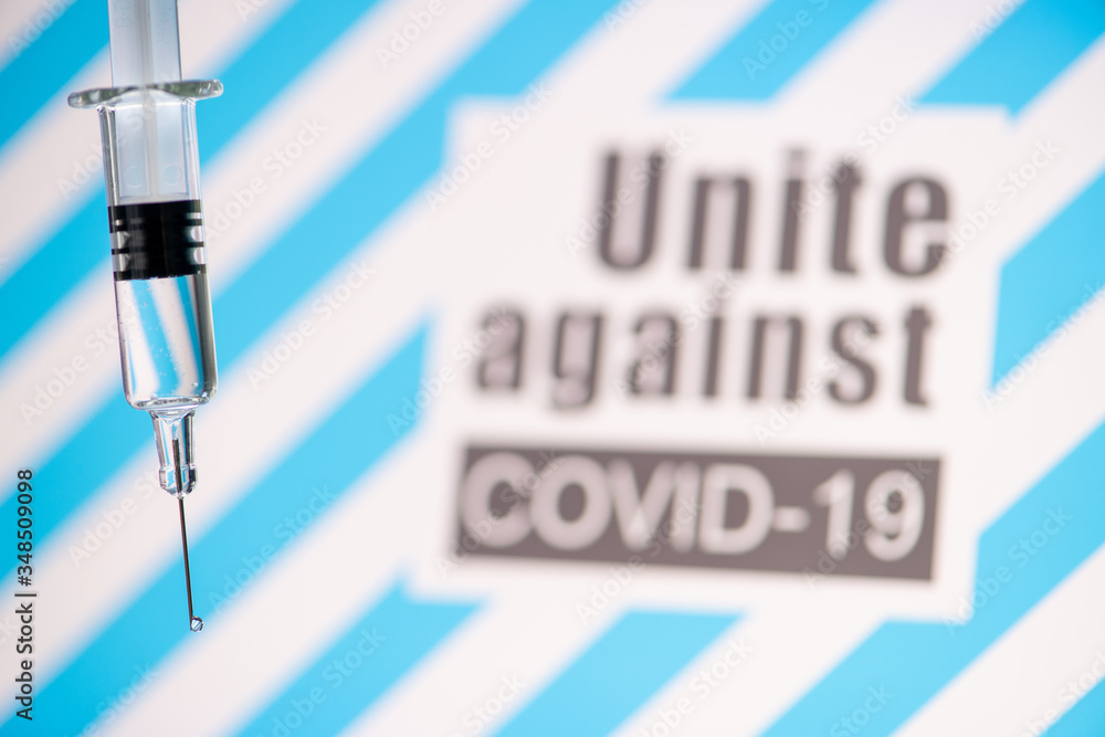 Text Unite against COVID-19 with glass syringe on blue background. Concept about vaccine of coronavirus or COVID-19. Text Unite against COVID-19 with glass syringe on blue background. Concept about vaccine of coronavirus or COVID-19.