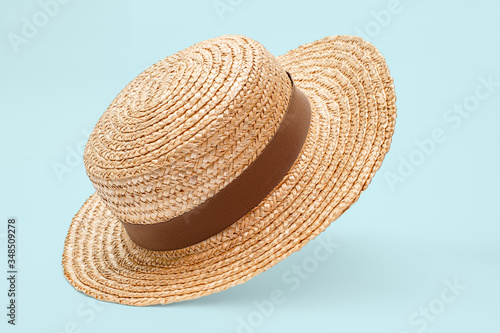 Foto Boater straw hat flying isolated in studio