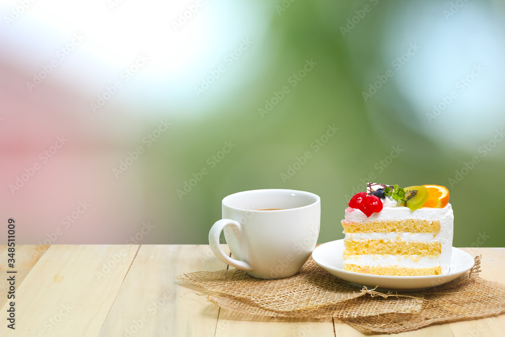 Slice cake with coffee cup on wood , green blur background Slice cake with coffee cup on wood , green blur background