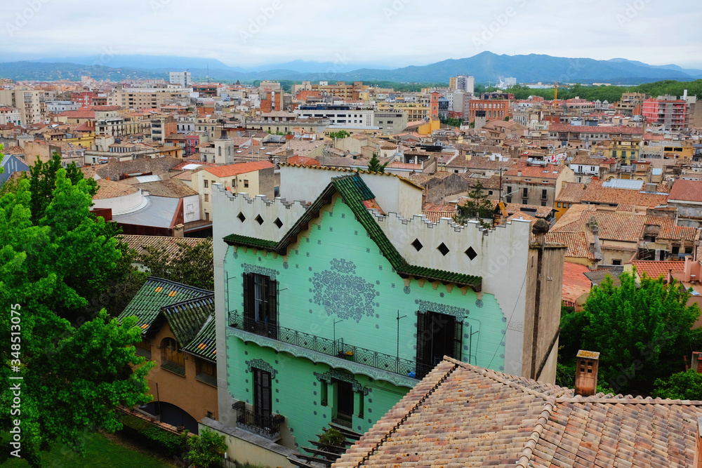 A view of the city of Girona, Spain. A beautiful old city perfect for traveling and exploring with mountains in the background and colourful buildings. 