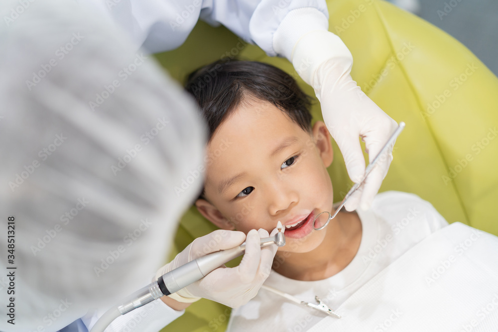 A boy having teeth examined at dentists: Healthy lifestyle, healthcare, and medicine concept. A boy having teeth examined at dentists: Healthy lifestyle, healthcare, and medicine concept.