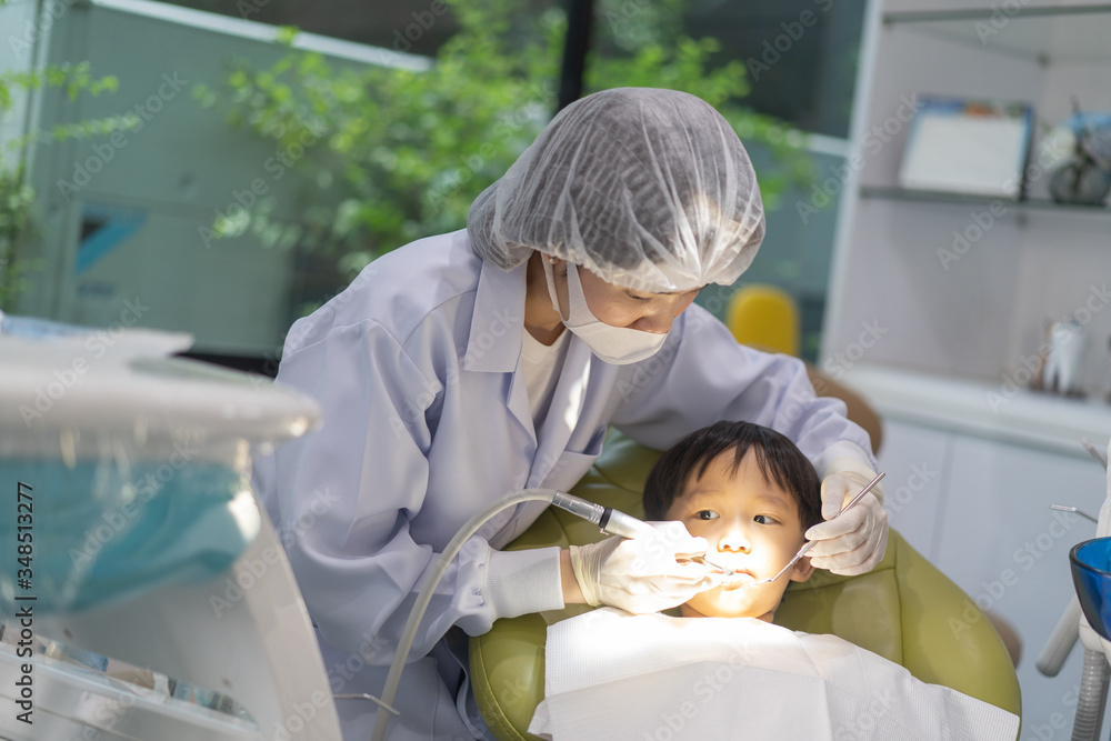 A boy having teeth examined at dentists: Healthy lifestyle, healthcare, and medicine concept. A boy having teeth examined at dentists: Healthy lifestyle, healthcare, and medicine concept.