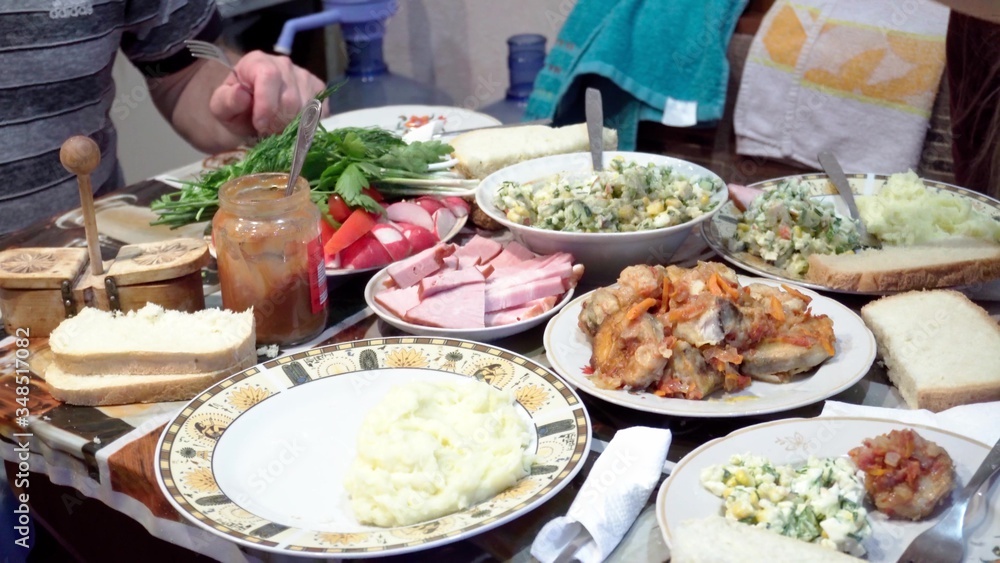 Dishes with homemade food on the dining table. Dishes with homemade food on the dining table.