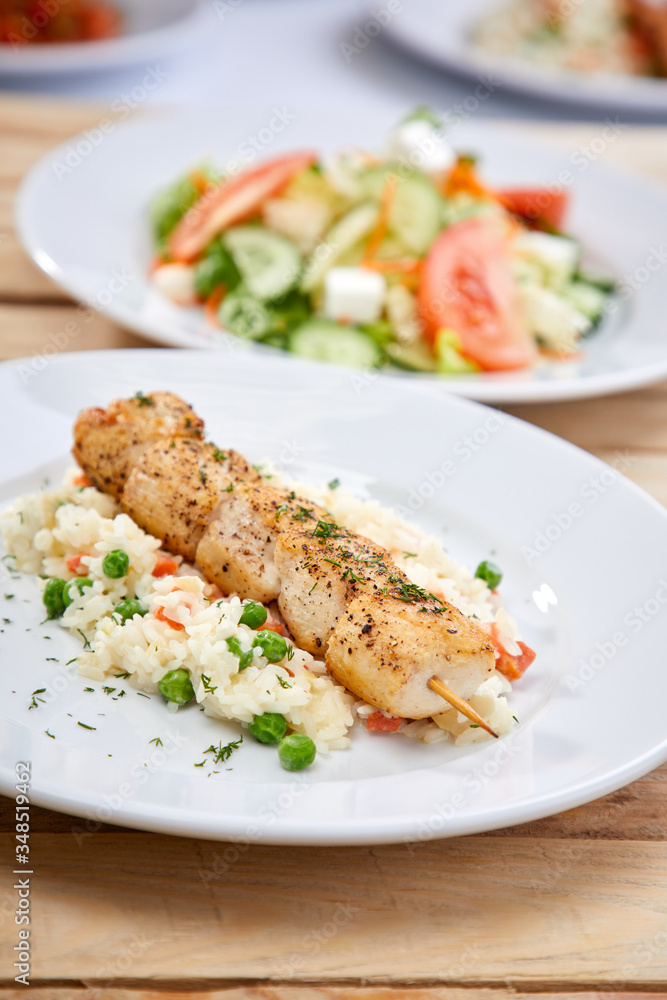 chicken kebab with rice and salad on the wooden background chicken kebab with rice and salad on the wooden background