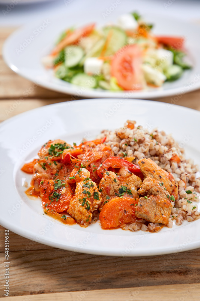 meat with buckwheat and salad on the wooden background meat with buckwheat and salad on the wooden background