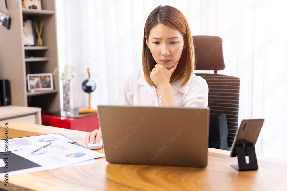 Young asian chinese ethnicity using laptop browsing,working,meeting or online learning at home Young asian chinese ethnicity using laptop browsing,working,meeting or online learning at home