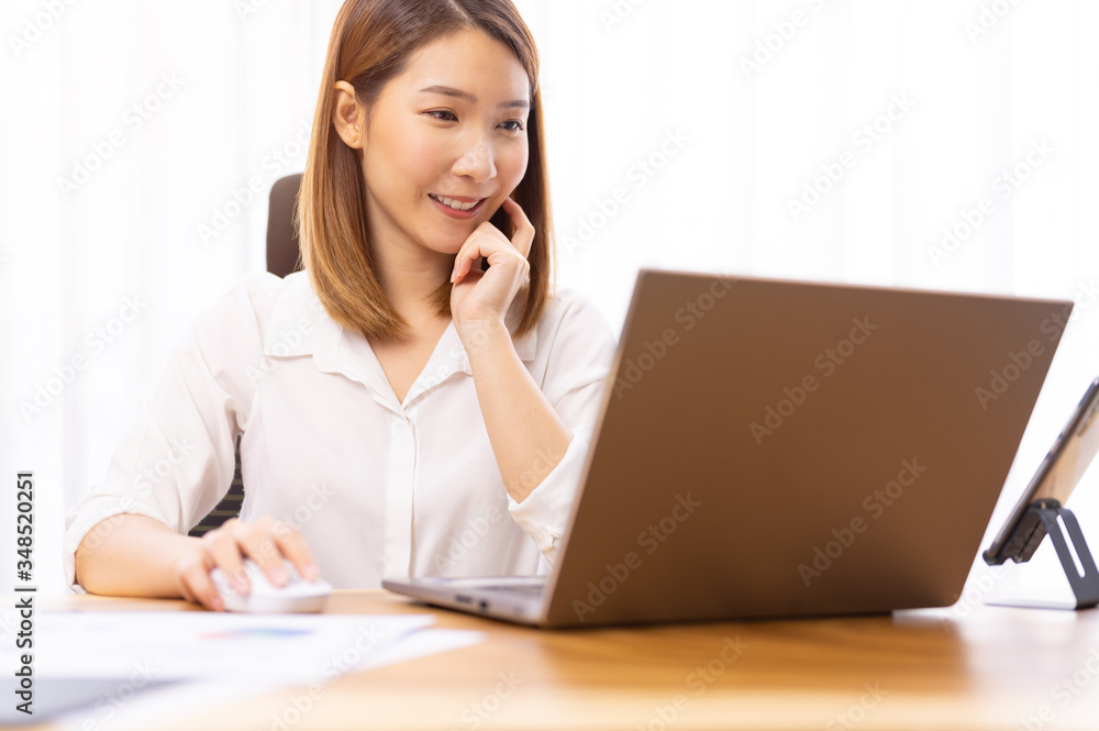 Young asian chinese ethnicity using laptop browsing,working,meeting or online learning at home Young asian chinese ethnicity using laptop browsing,working,meeting or online learning at home