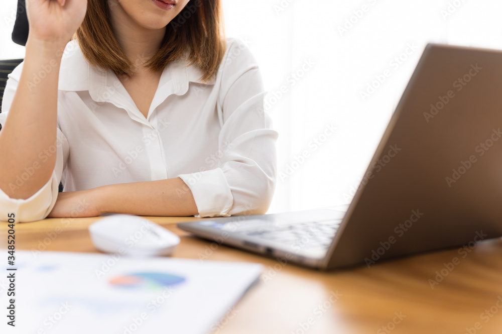 Fototapeta premium Young woman sale person analzing sale report on desk working at home