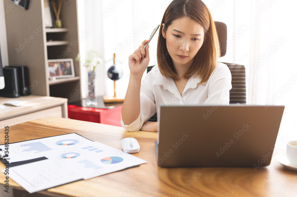 Stressed young Asian woman using laptop working at home Stressed young Asian woman using laptop working at home