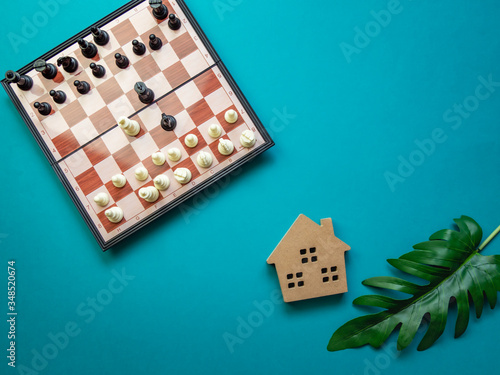 House wooden and chess ,Property investment and mortgage financial concept.