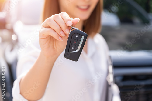 Car loan, contract agreement,buying and rent car concept, Saleperson holding car key on hand