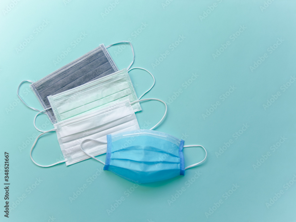 Surgical or medical face mask flat lay on blue background, Health care protection and surgical concept. Surgical or medical face mask flat lay on blue background, Health care protection and surgical concept.