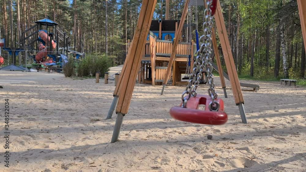 Empty swing swing at an indoor playground in a city park. Emergency declared after Riga Chovid-19 pandemic Empty swing swing at an indoor playground in a city park. Emergency declared after Riga Chovid-19 pandemic