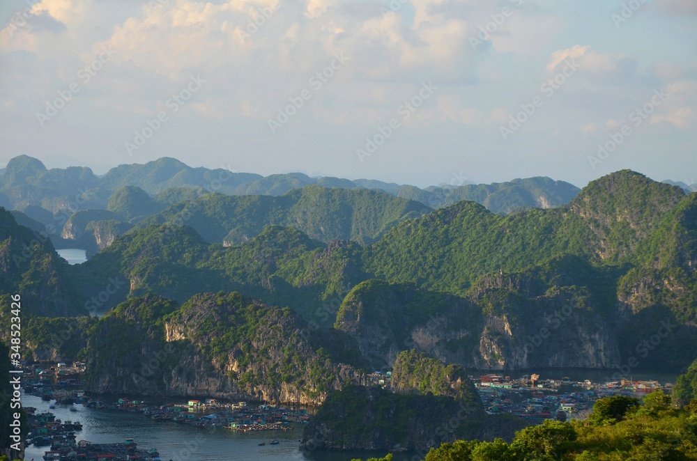 Afternoon sun throws shadows at the coastline of Halong Bay, Vietnam