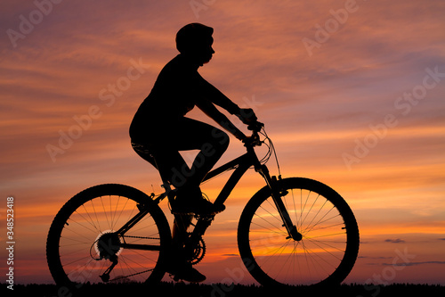silhouette of a cyclist against the sunset
