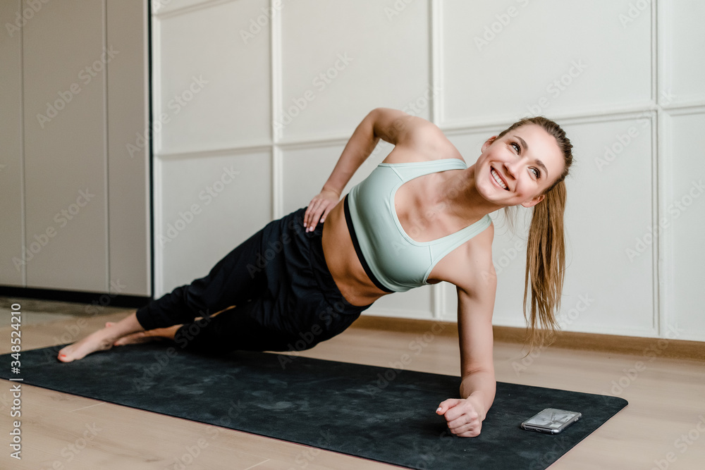 beautiful smiling woman doing sport exercise with phone on yoga mat at home beautiful smiling woman doing sport exercise with phone on yoga mat at home