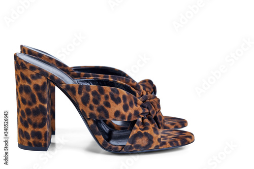 Pair of women's open sandals in high heel of leopard suede, isolated on a white background by a light shadow. Side view. photo