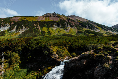 Waterfall in the mountain range. Kamchatka