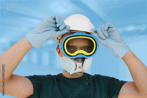 male, disinfector in a protective suit, respirator, goggles and helmet, biological and chemical weapons concept, coronavirus, COVID-19