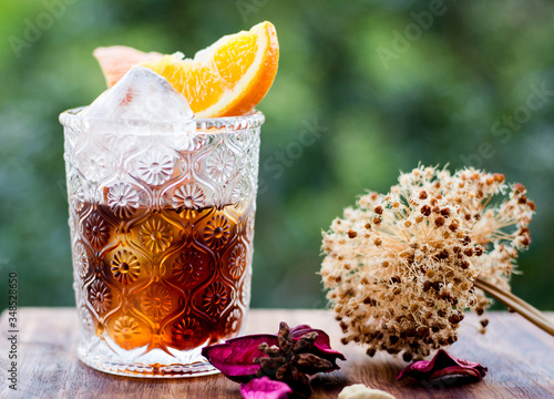 Glass of vermuth with slice of orange  photo