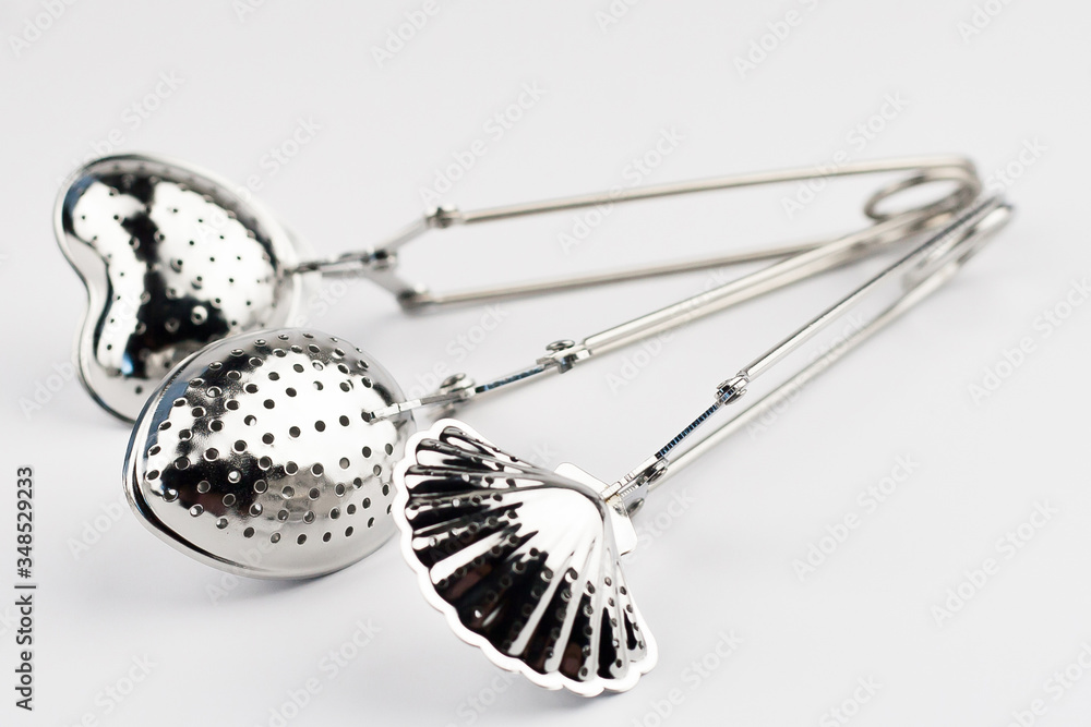 Different kinds of stainless tea strainers isolated on white background. Different kinds of stainless tea strainers isolated on white background.