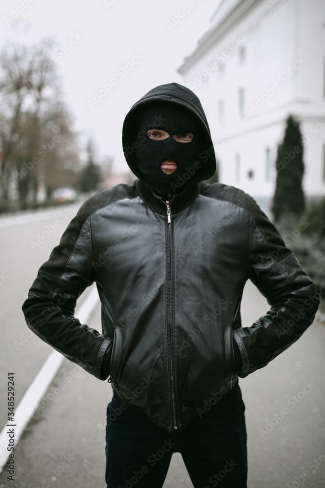 portrait of man thief in mask on the street