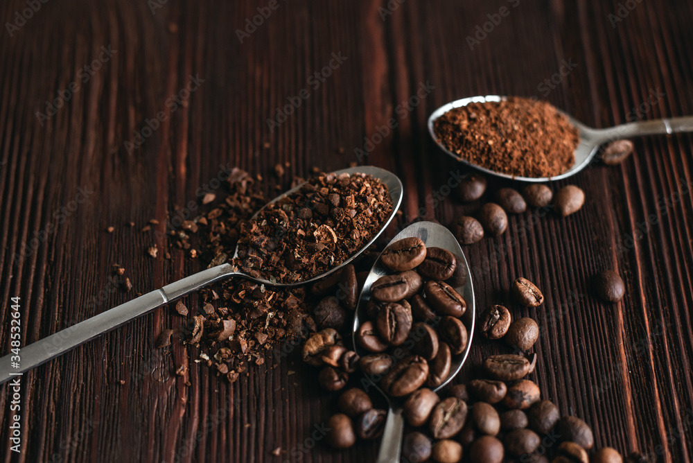 Roasted black coffee beans of different fractions on a dark table Roasted black coffee beans of different fractions on a dark table