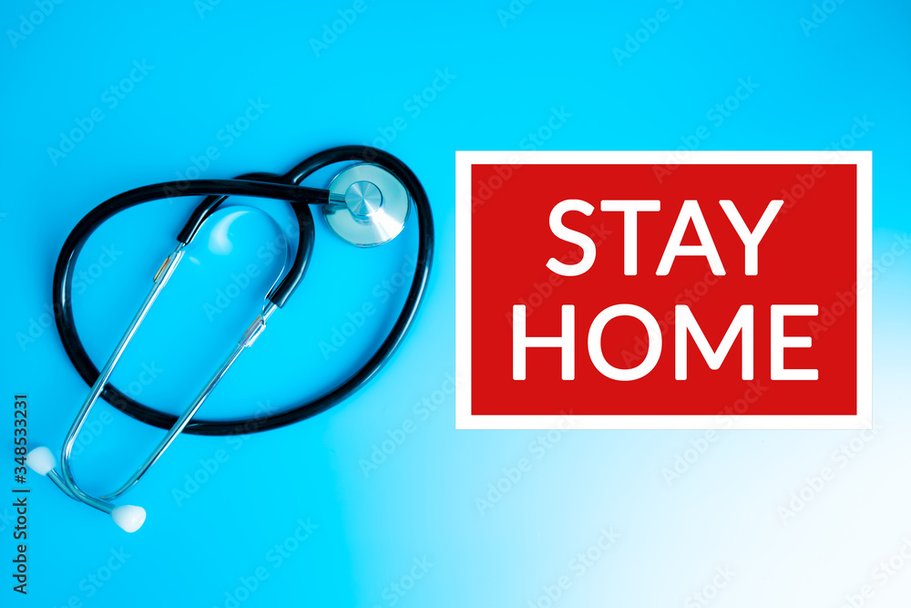 Medical, showing Stay Home sign on blue hospital banner background with Stethoscope. COVID-19 outbreak emergency workers. Coronavirus board panoramic corona virus text title. Medical, showing Stay Home sign on blue hospital banner background with Stethoscope. COVID-19 outbreak emergency workers. Coronavirus board panoramic corona virus text title.